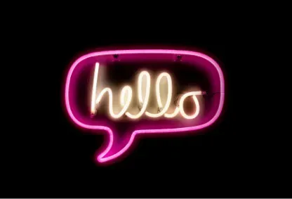 A neon sign in the shape of a speech bubble that says "hello"